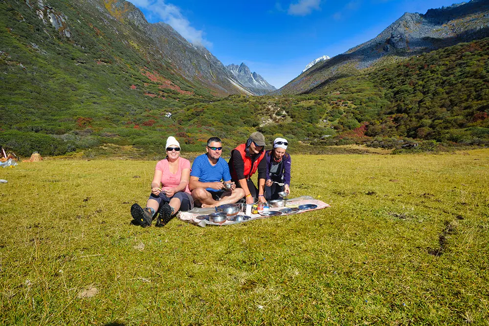 Trekkers taking a lunch break during a high-altitude Himalayan trek in Sikkim